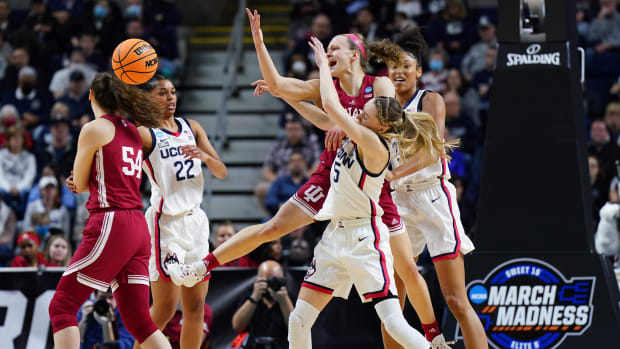 Grace Berger and Mackenzie Holmes defend the ball against UConn.